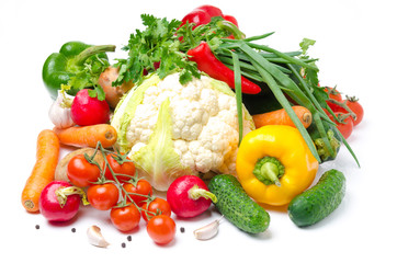 assorted fresh vegetables and greens on a white background