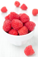 fresh raspberries in a bowl, vertical close-up