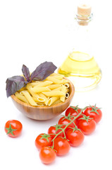 penne pasta, fresh tomatoes, basil, olive oil isolated on white