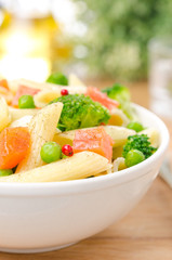 salad with pasta, smoked salmon, broccoli and green peas