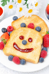 Toast with a smile out of a jam, fresh berries for breakfast