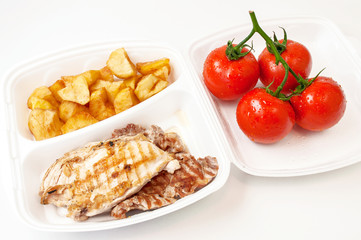 Roast meat, potatoes and fresh tomatoes in a casserole