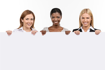 Three businesswoman with white board