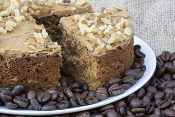 Coffee and walnut layer cake with cup of coffee