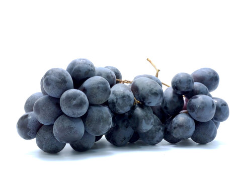 Black grapes isolated on white background.