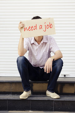 A man with a sign on the job search