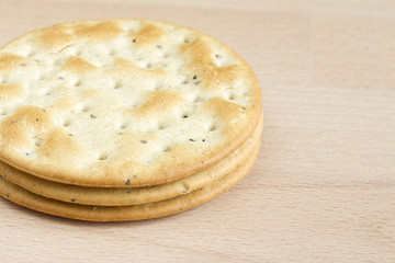 Three round crackers on a wooden board