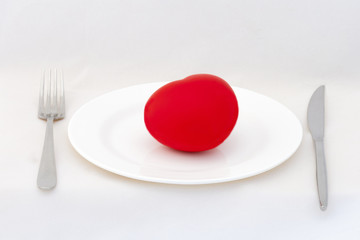 Red heart on plate with white background