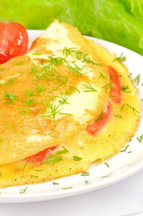Omelet with herbs and vegetables, close up view