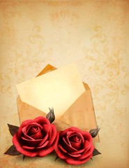 Two roses in front of an old envelope with a letter. Love letter