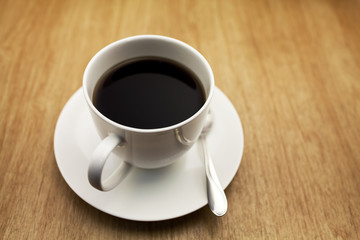 Coffee cup on the wood texture