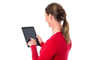 Fototapeta premium Smiling woman operating touch pad device