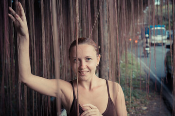 Fototapeta na wymiar Young woman standing in thick jungle vegetation