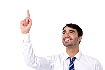 Cheerful male executive pointing upwards