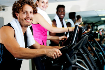 People at  gym working out happily
