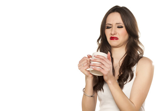 girl makes a disgusting face and refusing to drink his tea