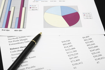 business financial chart analysis or empty market share benefit circle graph with pen on paper work or document report on black table and background