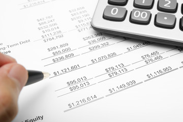 business financial chart analysis with calculator, pen & hand