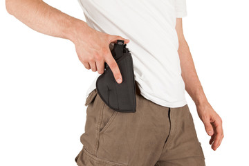 Close-up of a man with his hand on a gun