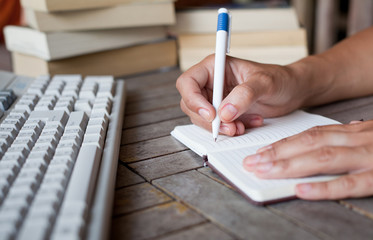 abstract hands writing in notepad, education
