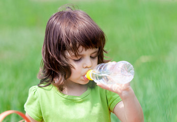 Little girl drinking water from bottle