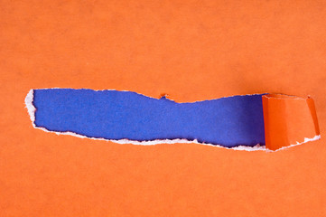Torn paper with opening showing blue background