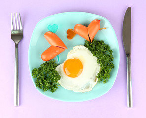 Sausages in form of hearts, scrambled eggs and parsley,