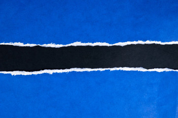 Torn blue paper with black space