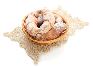 Taste croissants in basket isolated on white.