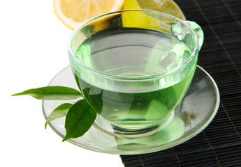 Transparent cup of green tea with lemon
