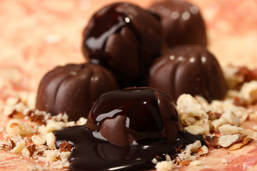 Chocolate candies with nuts, on color background