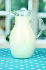 Pitcher of milk on table in room
