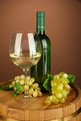 Composition of wine bottle, glass of white wine, grape