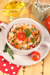 Delicious rice with vegetables and herbs in pot