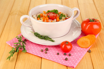 Delicious rice with vegetables and herbs in pot