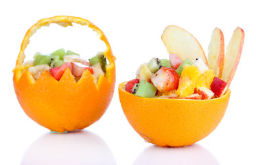 Fruit salad in hollowed-out orange isolated on white
