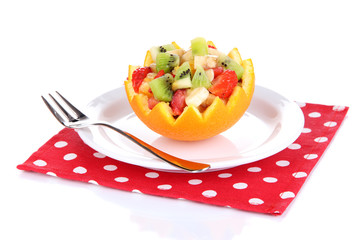 Fruit salad in hollowed-out orange isolated on white
