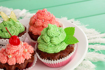 Delicious beautiful  cupcakes on dining table close-up