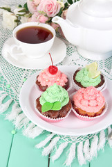 Delicious beautiful  cupcakes on dining table close-up