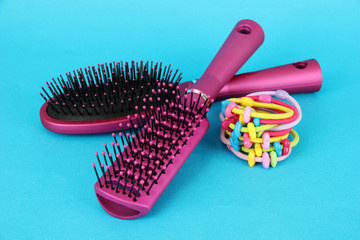 Scrunchies, hairbrush  and  hair - clip   on a blue background