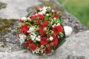 Brides bouquet of red and white roses before wedding