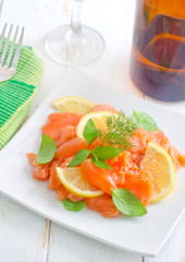 fresh salmon with lemon on the white plate