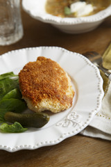 Chicken kiev with baby spinach and gherkin