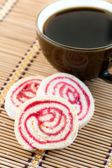 Strawberry and lemon jam swiss roll and cup of coffee