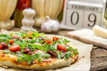 Close-up on baked pizza with ham