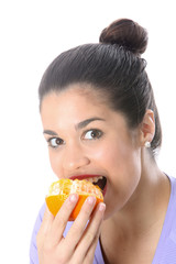Model Released. Young Woman Eating an Orange