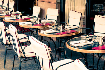 Street view of a coffee terrace with tables and chairs