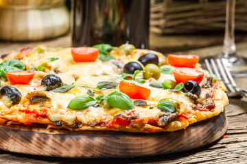 Closeup of freshly baked pizza served with wine