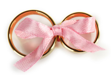 Wedding rings tied with ribbon isolated on white