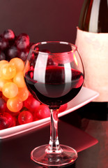 Glass of wine with lipstick imprint, grapes and bottle